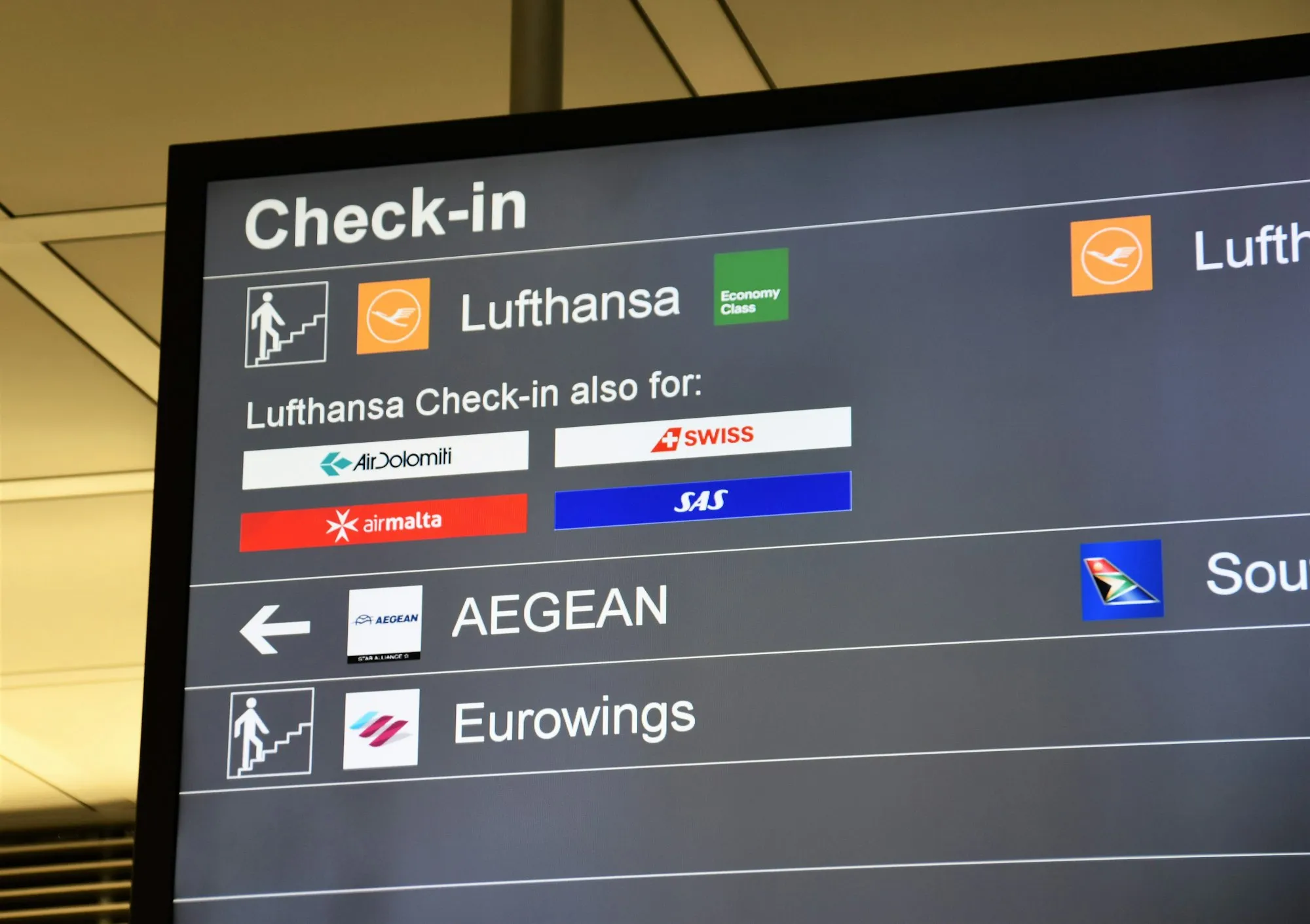 An airport check-in screen showing Lufthansa check-in shared with SWISS, SAS, Air Dolomiti and Air Malta