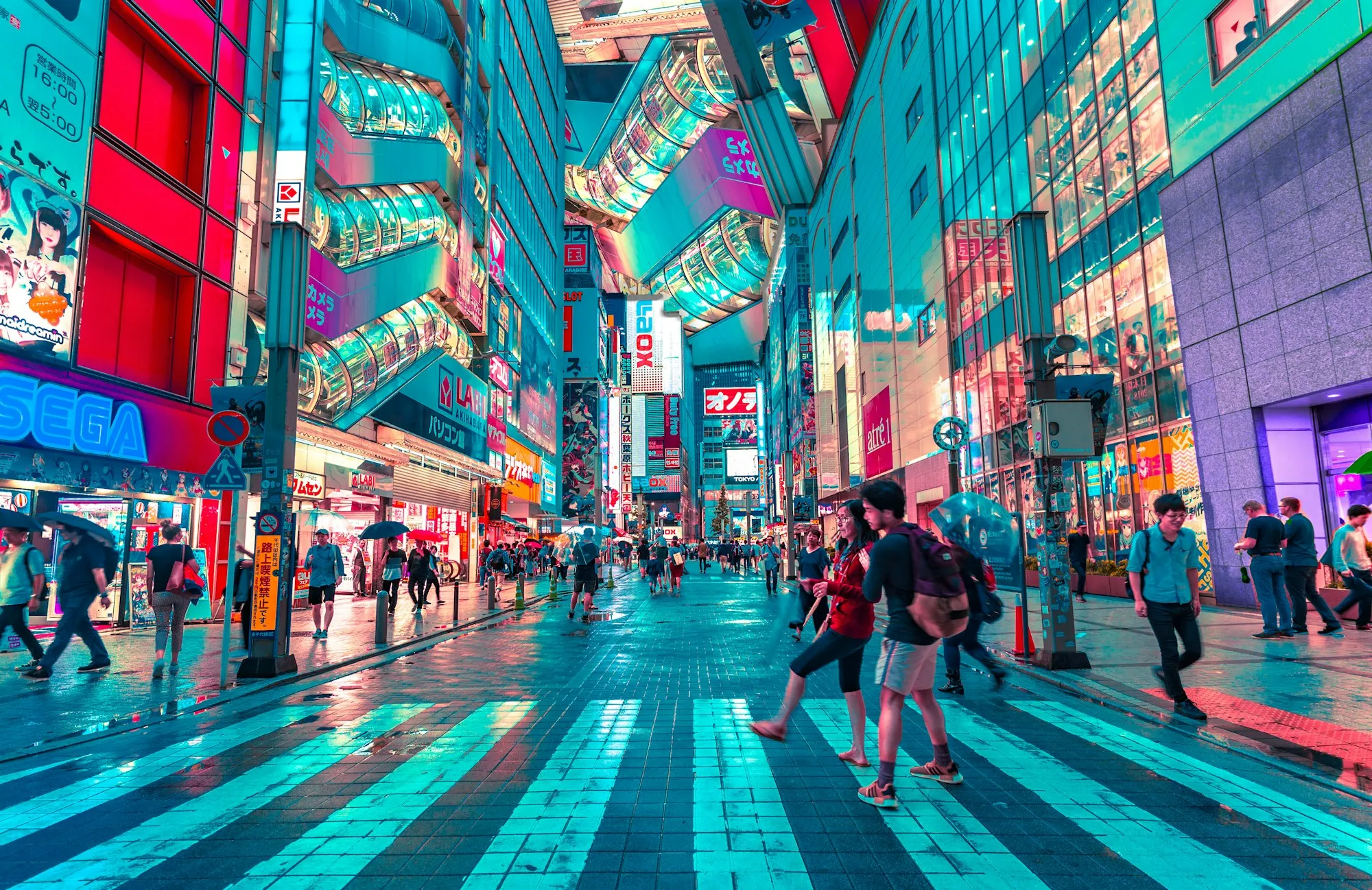 A neon-lit Tokyo street at night, crowded with pedestrians beneath illuminated signage